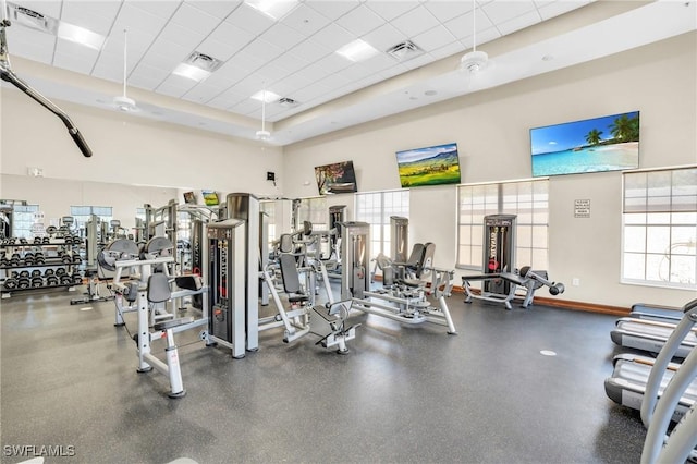 workout area featuring baseboards, visible vents, and a drop ceiling