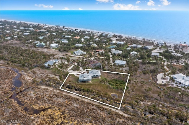 bird's eye view featuring a water view and a view of the beach