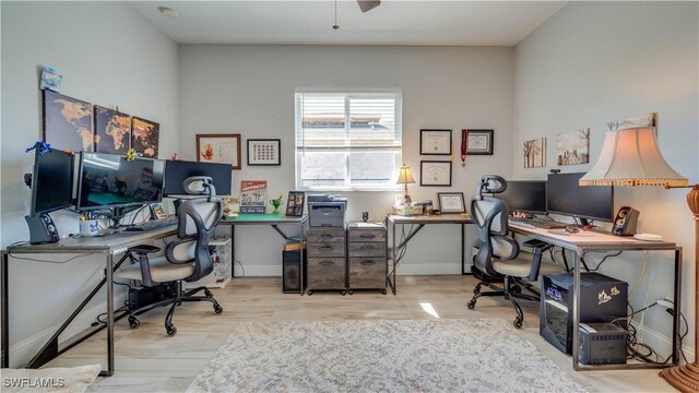 office space featuring wood finished floors, a ceiling fan, and baseboards