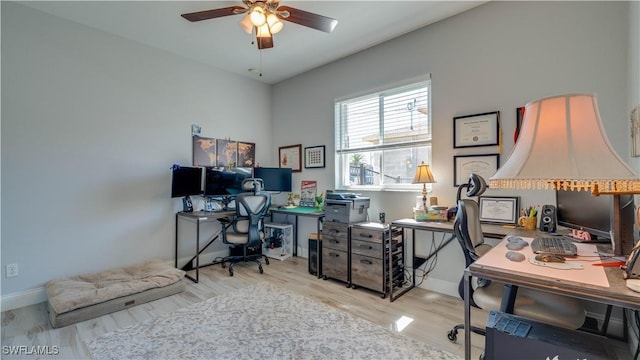 office area featuring ceiling fan, baseboards, and wood finished floors