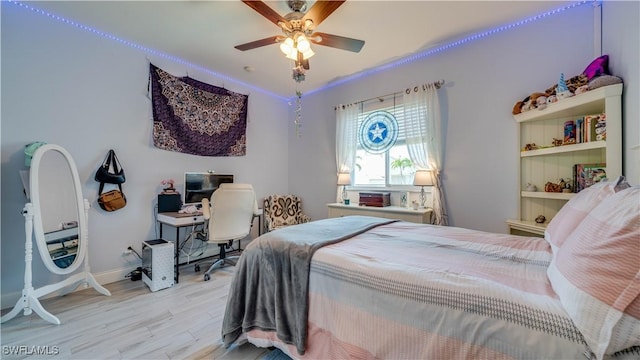 bedroom featuring light wood-type flooring, a ceiling fan, and baseboards