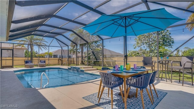 view of swimming pool with glass enclosure and a patio area