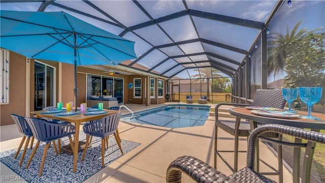 pool with a ceiling fan, glass enclosure, and a patio area