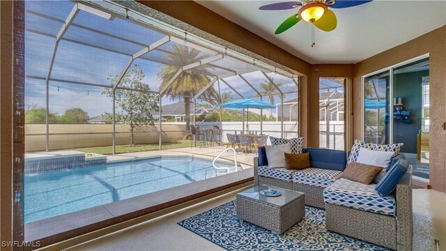 view of swimming pool with a lanai, a patio area, outdoor lounge area, and a ceiling fan