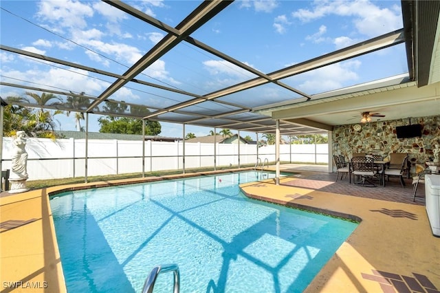 view of pool with glass enclosure, a patio area, fence, and a fenced in pool