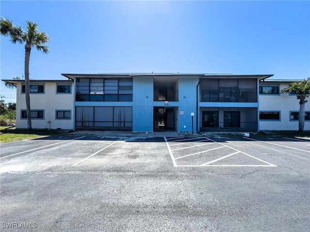 view of building exterior with uncovered parking