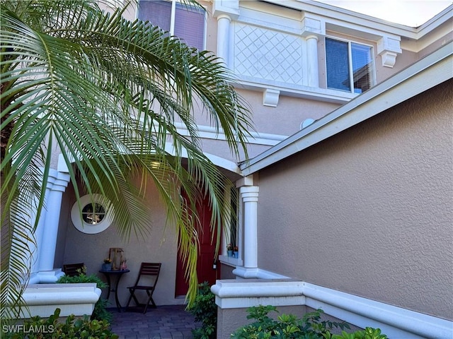 entrance to property featuring stucco siding