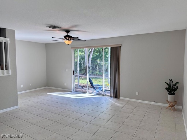 unfurnished room with visible vents, ceiling fan, and baseboards