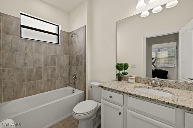 bathroom featuring toilet, bathtub / shower combination, and vanity