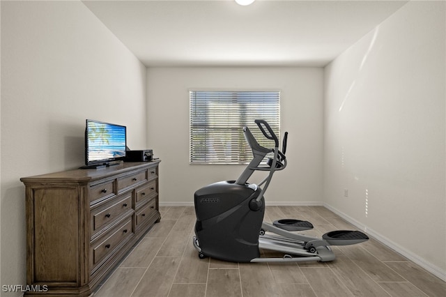 workout area with wood tiled floor and baseboards