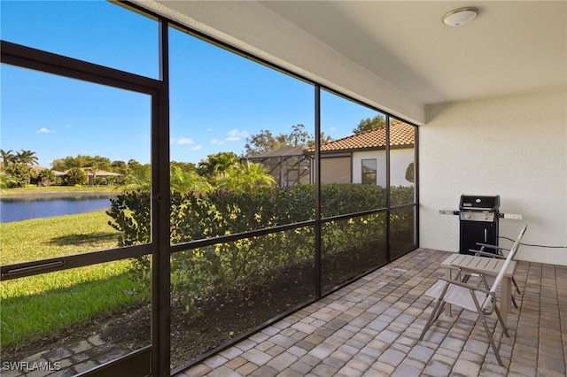 sunroom / solarium with a water view