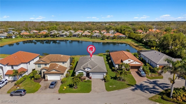 drone / aerial view featuring a water view and a residential view