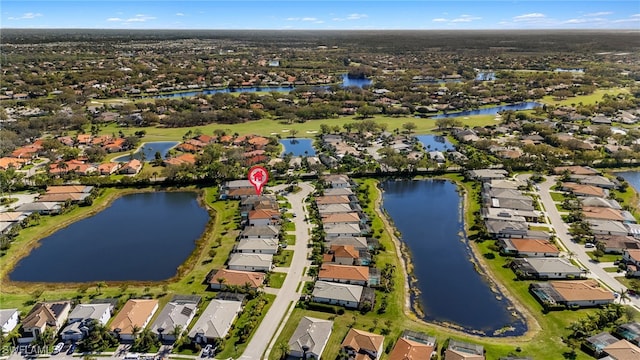 drone / aerial view featuring a water view and a residential view