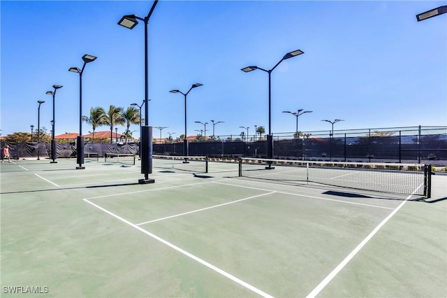 view of tennis court with fence