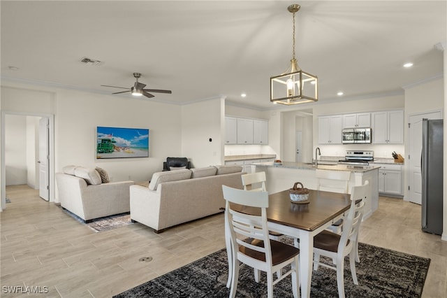 dining space with recessed lighting, visible vents, crown molding, and light wood finished floors