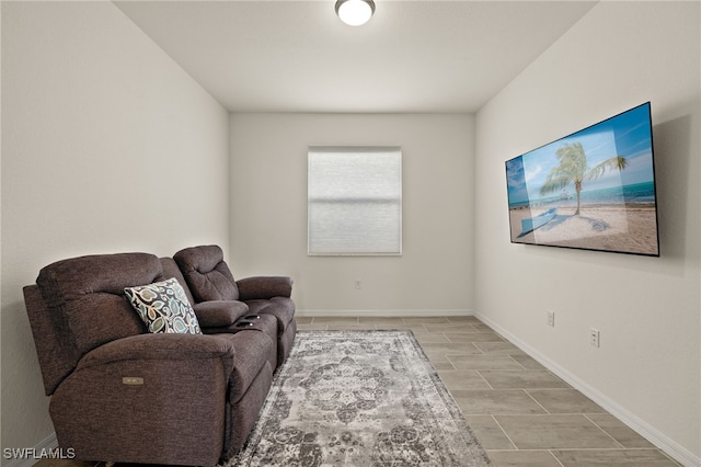 sitting room with baseboards and wood finish floors