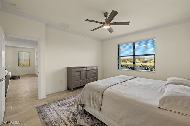 bedroom featuring wood tiled floor, visible vents, crown molding, and baseboards