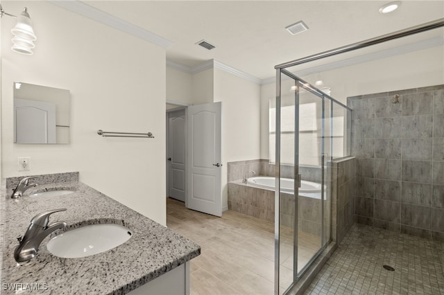 full bathroom featuring ornamental molding, a sink, visible vents, and a shower stall