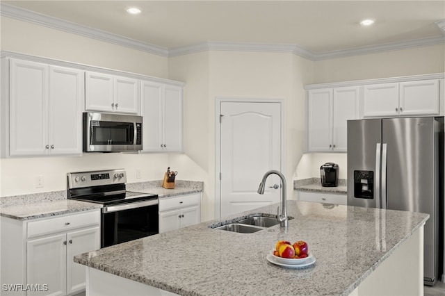 kitchen with a sink, white cabinets, appliances with stainless steel finishes, light stone countertops, and crown molding