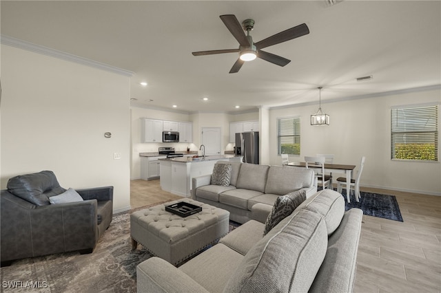 living room with light wood finished floors, visible vents, ceiling fan, crown molding, and recessed lighting