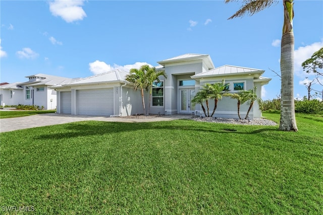 view of front of house with an attached garage, a standing seam roof, a front lawn, and decorative driveway