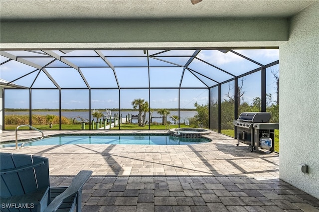 view of pool with a pool with connected hot tub, a patio area, area for grilling, and a lanai