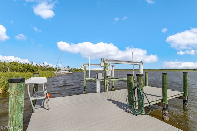 view of dock featuring a water view and boat lift