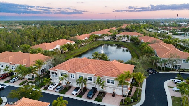 aerial view featuring a forest view, a water view, and a residential view