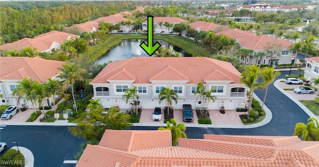 birds eye view of property featuring a water view and a residential view