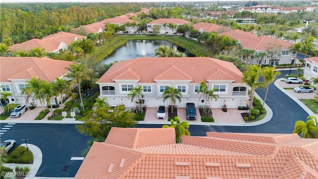 drone / aerial view featuring a residential view and a water view