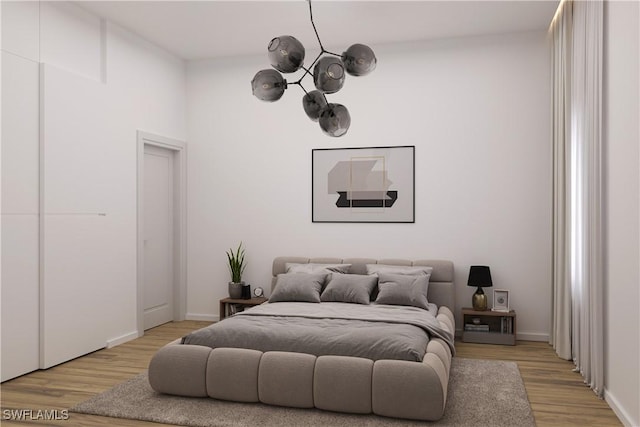 bedroom with light wood-style flooring and baseboards