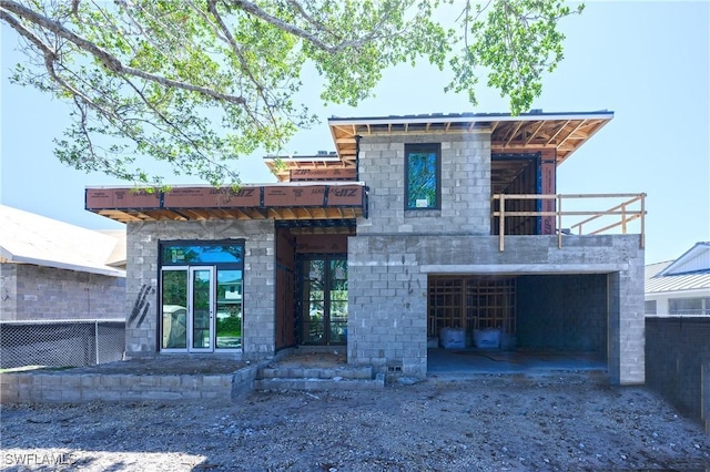 view of front of house featuring a garage, driveway, and fence