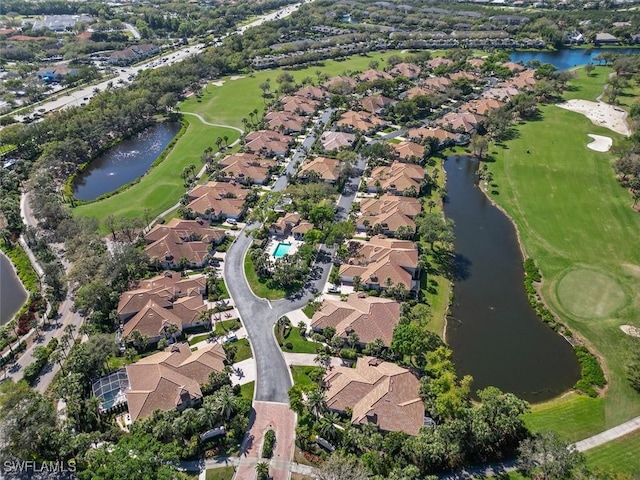 bird's eye view featuring view of golf course, a water view, and a residential view