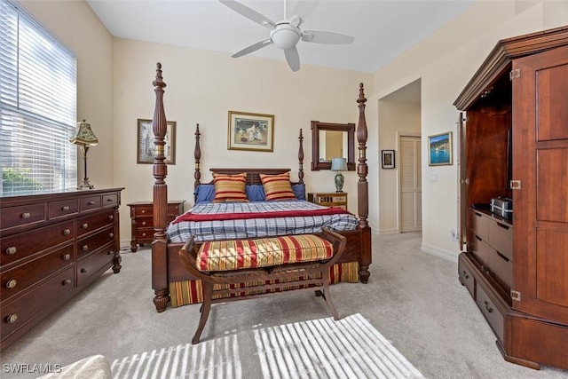 bedroom with light carpet, a ceiling fan, and baseboards