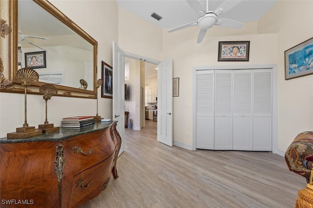 interior space with a closet, baseboards, light wood-type flooring, and a barn door