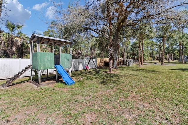 view of play area with a lawn and fence