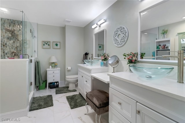 full bath with marble finish floor, two vanities, a sink, and a shower stall