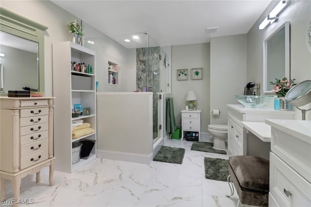 full bath featuring a stall shower, marble finish floor, vanity, and toilet