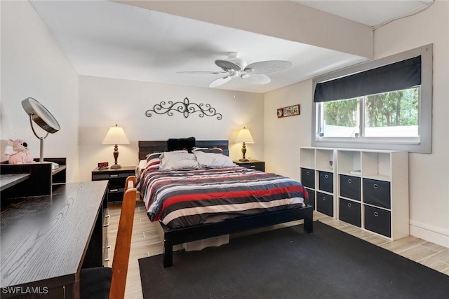 bedroom with wood finish floors and a ceiling fan