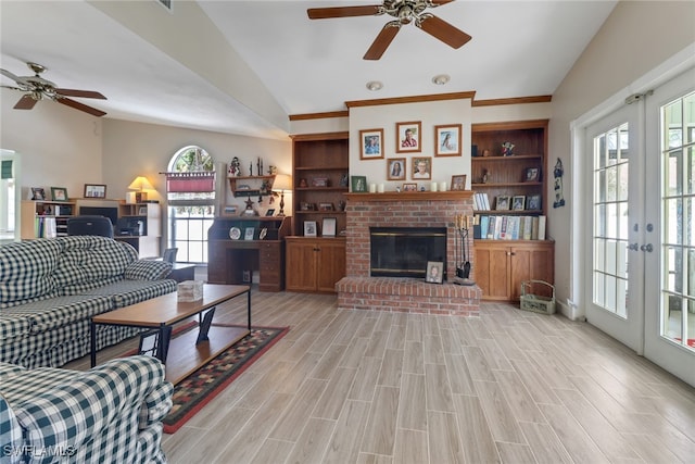 living room featuring lofted ceiling, a fireplace, french doors, a wealth of natural light, and light wood finished floors