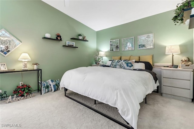 bedroom featuring carpet and vaulted ceiling