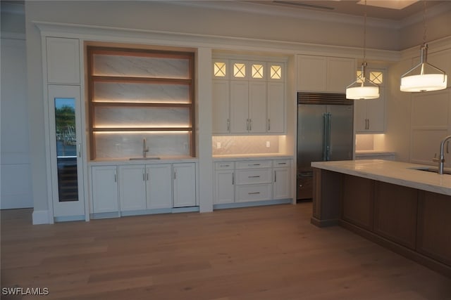 713 Nautilus Ct, Marco Island, FL 34145 - kitchen featuring stainless steel built in fridge, white cabinetry, pendant lighting, and light wood-style floors
