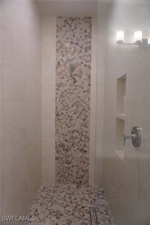 713 Nautilus Ct, Marco Island, FL 34145 - bathroom featuring tiled shower