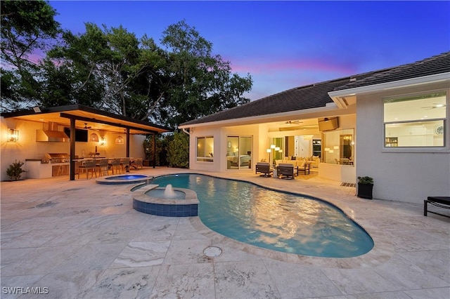 8133 Ronda Ct, Naples, FL 34109 - view of pool featuring an outdoor kitchen, a ceiling fan, outdoor lounge area, a patio, and a pool with connected hot tub