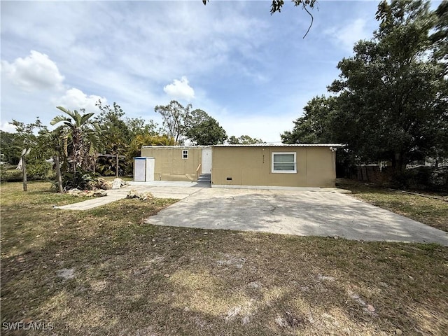 rear view of property featuring entry steps and a patio area