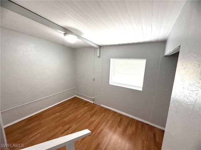unfurnished room with wood ceiling, baseboards, and wood finished floors