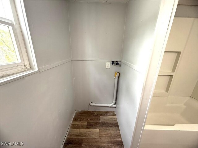 bathroom featuring wood finished floors and a bath
