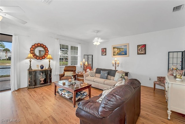 living room with a ceiling fan, a healthy amount of sunlight, visible vents, and light wood-style floors