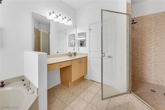 bathroom featuring a garden tub, a shower stall, vanity, and tile patterned floors