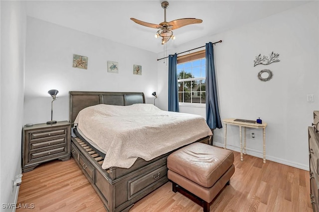 bedroom with a ceiling fan, light wood-style flooring, and baseboards